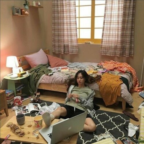 Lady sitting in a cluttered room