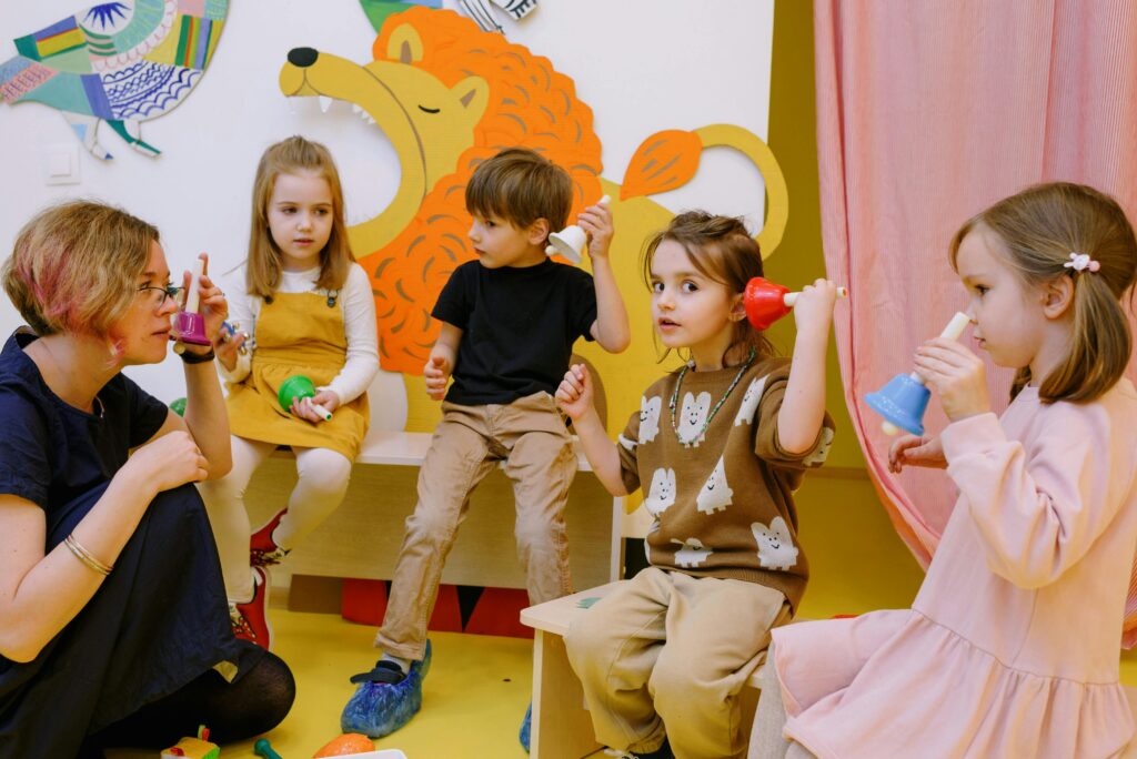 Teacher-with-her-students-holding-different-color-bells